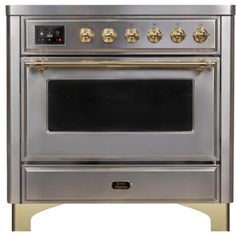 a silver oven with gold knobs on the front and side doors, sitting against a white background