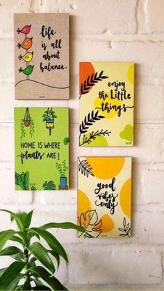 three canvases hanging on the wall with some plants in front of them and one saying life is all about balance