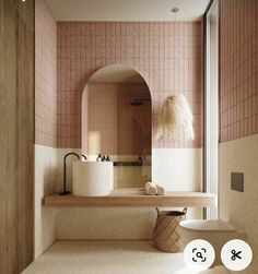 a bathroom with pink tiles and white fixtures