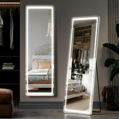 a large mirror sitting on top of a floor next to a bed