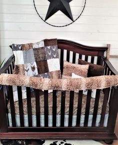 a baby crib in front of a wall with a black star on the top