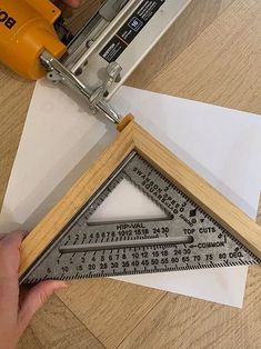 a person using a ruler to cut paper