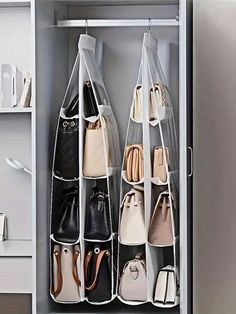 an organized closet with handbags and purses hanging on the wall in front of it