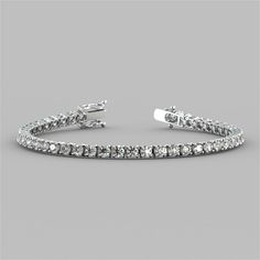 Spoil yourself or that someone special with this divine bracelet. Stunningly classic, 49 round cut Simulated Diamonds with a total weight of 8.67CTW radiate beautifully within a classic 4-prong setting. Enclosed by a box clasp to ensure your precious piece is always secure, this tennis bracelet is the perfect touch to any look.    8.67CTW Classic Round Cut Tennis Bracelet;  Stone Clarity: VVS-1;  Available in:14K White or Yellow Gold;  Length: 7 inches;  Model: B3557A; Bracelet Stone, Ankle Chain, Halo Earrings, Weird Stuff, Spoil Yourself, Box Clasp, Free Earrings, Someone Special, Womens Wedding Bands