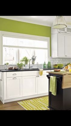 the kitchen is clean and ready for us to use it's counters are white with black counter tops