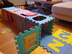 a child's play room with toys on the floor and in front of it