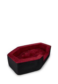 a red and black dog bed on a white background