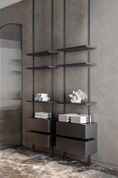 a shelf with towels and cups on it in front of a wall mounted shelving unit