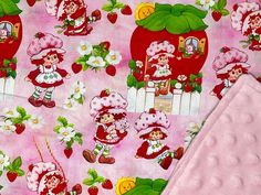 the pink fabric has strawberrys and gnomes on it