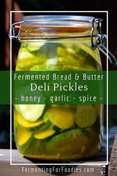 a jar filled with pickles and sliced cucumbers on top of a wooden table