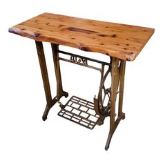 a wooden table with an old sewing machine on it's stand, against a white background