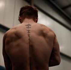 a man with a flower tattoo on his back