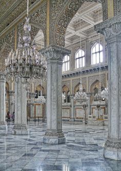 the interior of an ornate building with chandeliers and marble flooring is shown