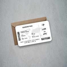 a boarding pass sitting on top of a brown envelope