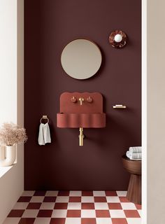 a bathroom with red and white checkered flooring next to a wall mounted mirror