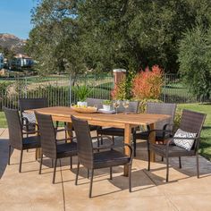 an outdoor dining table and chairs on a patio