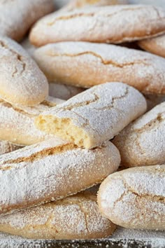 powdered sugar filled donuts piled on top of each other