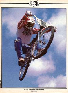 a person on a bike in the air doing a trick over some clouds and blue sky