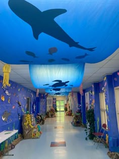 the hallway is decorated in blue and has an underwater theme