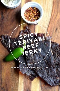 spicy teriyaki beef jeky on a cutting board with peppers and seasonings