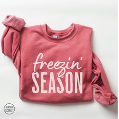 Funny Freezin' Season sweatshirt. This cozy winter holiday crewneck sweatshirt is a must for anyone who embraces the season with dry humor. If you're looking for a cute winter sweater to wear during the holidays, or need the perfect holiday sweater gift for her, this crewneck is the ideal choice. It will also makes an awesome gift for teen girls who'll appreciate the funny saying. H O W ∙ T O ∙ O R D E R * Select a Color * Select a Size based on the Size Chart * Add to Cart * Please check the Shipping Address to ensure that your order arrives without delay ♡ P R O D U C T∙ D E T A I L S * Brand: Gildan * Fabric: Medium-heavy weight. 50% cotton, 50% polyester. Ribbed knit collar. * Fit: Runs true to size. Please size up for an oversized look * Your shirts are carefully made with attention t Cozy Season Sweatshirt, Winter Sweatshirt Ideas, Funny Sweatshirts For Women, Cute Christmas Sweatshirts, Cricut Sweater, Winter Shirts For Women, Freezin Season, Cute Winter Sweater, Cute Winter Sweaters