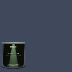 a can of behr marquee paint on a green background