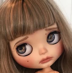 a close up of a doll with big eyes