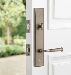 an open door with a handle on the front and side doors, in front of some trees