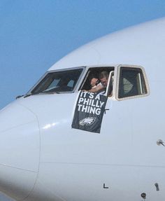 a man is sitting in the window of an airplane