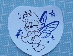 a sticker with a cartoon character on it's face and wings in the shape of a heart