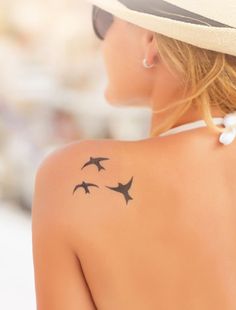 a woman with tattoos on her back and the words 11 tattoo designs for moms