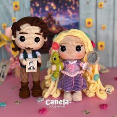 two crocheted dolls are standing next to each other on a table with confetti