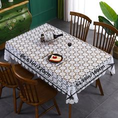 a dining room table covered with a personalized tablecloth