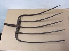 four metal tongs sitting on top of a cardboard box