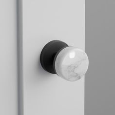 the door knob is black and white with a marbled ball on it's side