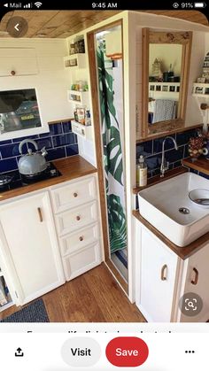 a kitchen with white cabinets and blue tile on the walls is pictured in this image