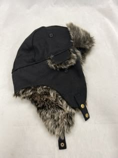 This is for a new with tags Sonoma faux fur trapper hat for a man.  One size fits most.  The color is black. The adjustable flaps can be worn up or down to keep your ears warm and the quilted interior adds extra comfort. The snap closure ensures a secure fit. Retails $32.  Comes from a smoke free home.  Once payment has been received I will ship out the same day or the next morning.  Thanks for looking. Seller's ID #F195 Wolf Party, Ushanka Hat, Fur Trapper Hat, Fur Trapper, Russian Hat, Trapper Hat, Party Inspo, Trapper Hats, Fur Hat