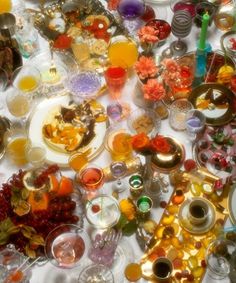 a table topped with lots of different colored dishes