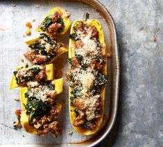 stuffed squash with meat, cheese and spinach on a baking sheet ready to be cooked