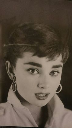 black and white photograph of a woman with large hoop earrings