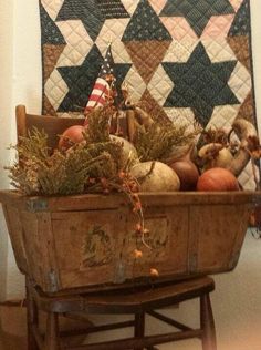 a wooden basket filled with lots of different types of fruits and vegetables on top of a table