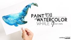 someone is painting a blue whale with watercolor