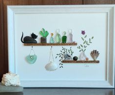 there are two shelves with sea shells and other items on them in front of a wall