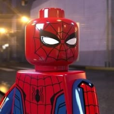 a lego spider - man is standing in the street