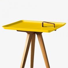 a yellow tray sitting on top of a wooden table