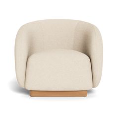 an upholstered chair with wooden legs and a white fabric cover on the back