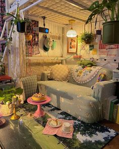 a living room filled with furniture and lots of plants on top of the table in front of it