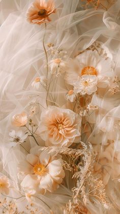 an artistic photo with flowers in the middle and sheer fabric around it's edges