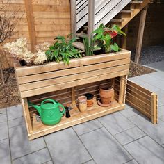 a wooden planter filled with potted plants