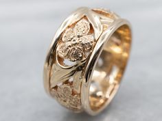 This piece dates to about the 1950s but still carries over a few hints of the preceding era. The craftsmanship is exquisite, with a wide, scrolling latticework at the center. Textured flowers are stationed at points along the way! This sits very low to the hand and will go well with a variety of styles of engagement pieces, or worn alone.Metal: 14K Yellow GoldWidth of Band: 9.4 mmHeight off Finger: 1.9 mmRing Size: 6.50Marks: “AIRES 14K” Stamped on the inside band Floral Wedding Band, Floral Wedding Bands, Vintage Wedding Ring, Wide Wedding Bands, Floral Filigree, Wedding Rings Vintage, Gold Pattern, Womens Wedding Bands, Gold Floral